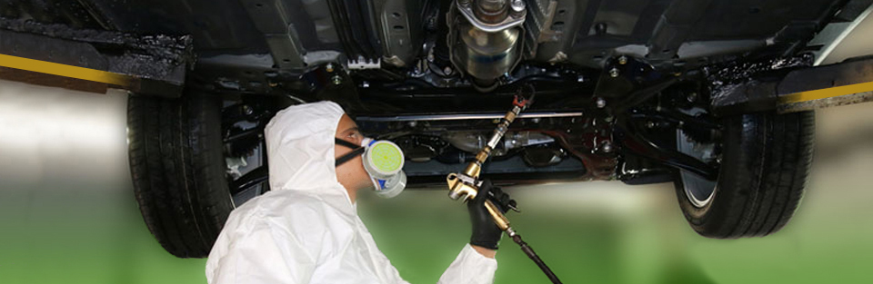Technician Applying Corrosion-FREE Oil Guard Rustproofing on Underside of Vehicle